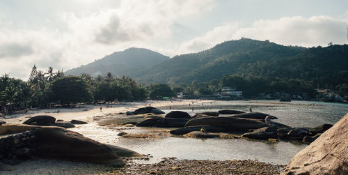 Scenic view of river against mountains and sky on sunny day