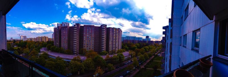 Panoramic view of cityscape against blue sky