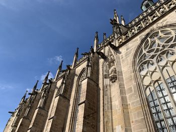 Low angle view of historical building, a minster, against sky