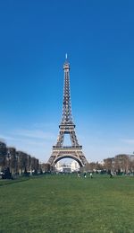 Tower in city against clear blue sky