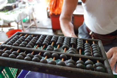 Midsection of man by abacus