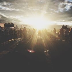 People walking in city at sunset