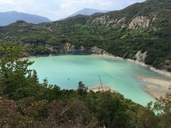 High angle view of lake and mountains against sky