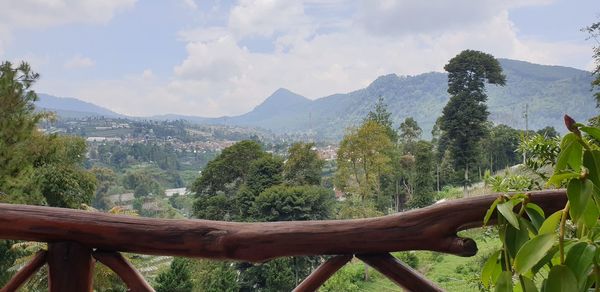 Scenic view of trees and mountains against sky