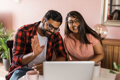 Young woman using laptop at home