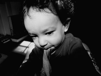 Sunlight falling on boy with napkin in mouth at home