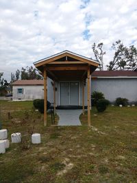 Exterior of old house on field against sky