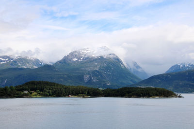 Scenic view of mountains and glacier and the hardangerfjord against cloudy sky