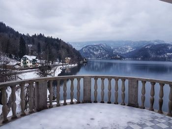 Scenic view of lake by snowcapped mountains against sky