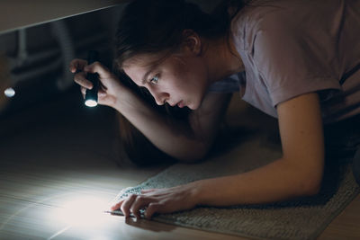 Portrait of woman sitting on bed at home