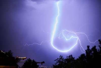 Low angle view of lightning in sky at night