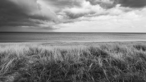 Scenic view of sea against cloudy sky