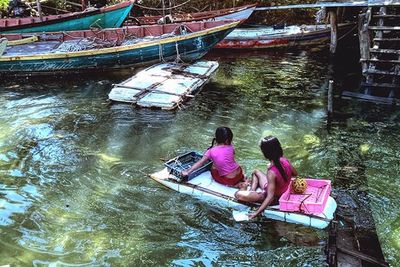 People sitting on boat in lake