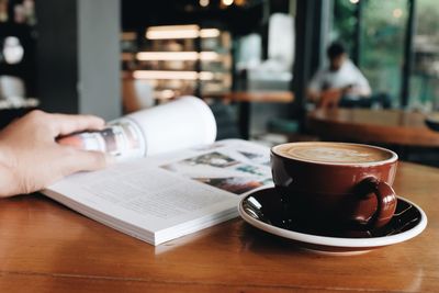 Midsection of coffee cup on table