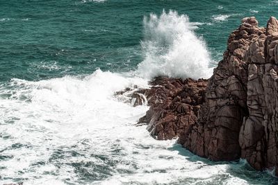 Waves splashing on rocks at shore