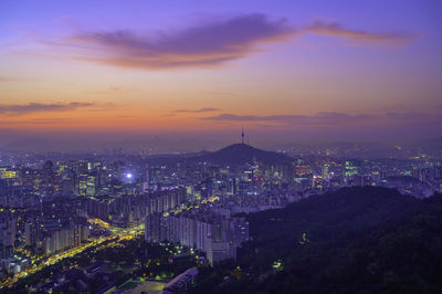 High angle view of illuminated buildings against sky during sunset