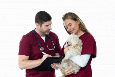 Young man holding a dog