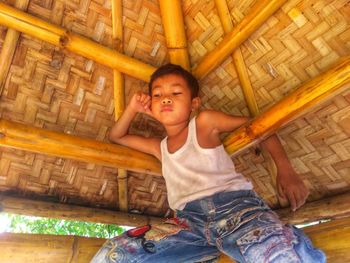 Boy sitting in hut