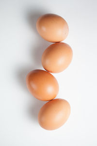 Close-up of eggs against white background