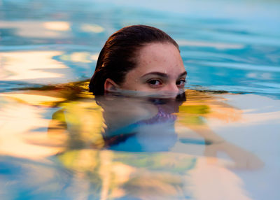 Portrait of woman swimming in pool