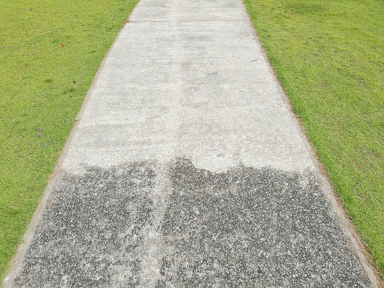 HIGH ANGLE VIEW OF ROAD BY GRASS