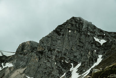 Low angle view of snowcapped mountain against sky