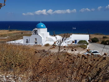 Scenic view of church snd sea against sky