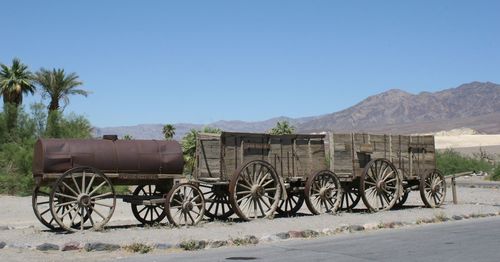 Rusty vehicles against clear sky