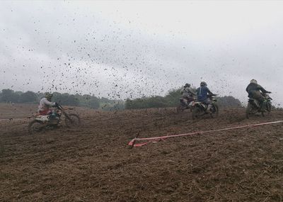 People working on field against sky