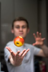 Close-up of man with apple