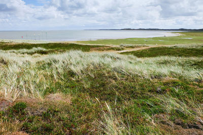 Scenic view of sea against cloudy sky