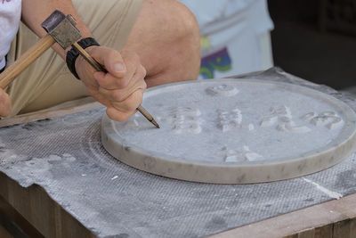 Midsection of man working at craft work in assisi, italy