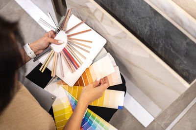 Cropped hand of woman holding shopping bags