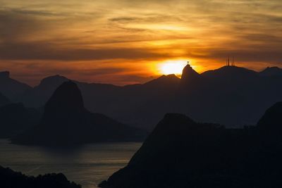 Scenic view of mountains against sky at sunset