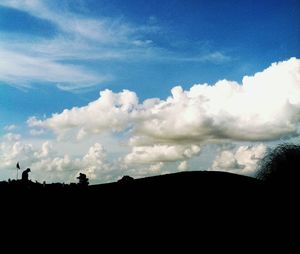 Low angle view of silhouette landscape against sky