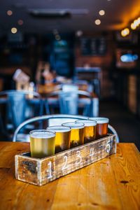 Beer glasses in flight on table in bar