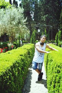 Portrait of young man on footpath in park