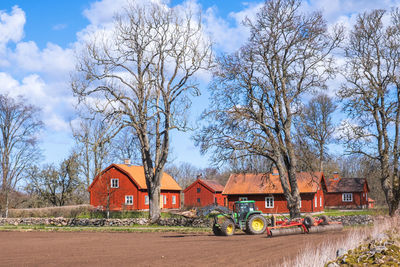 Tractor at spring working by a farm