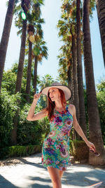 Woman wearing hat against trees