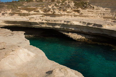 Saint peter's pool. rocky beach in malta