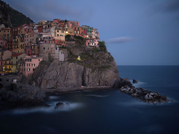 Panoramic view of sea and buildings against sky