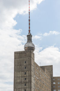 Low angle view of building against cloudy sky