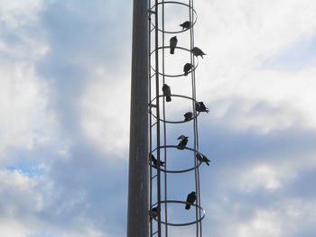 Low angle view of communications tower against sky