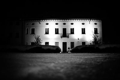 Surface level of street by illuminated building at night