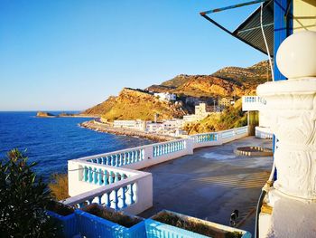 View of bay against clear blue sky