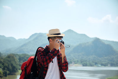 Man standing against mountain range