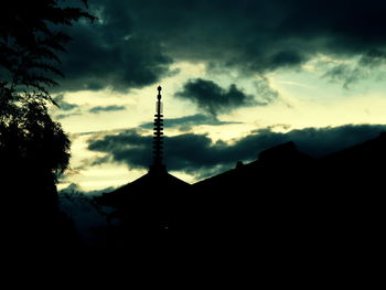 Low angle view of building against cloudy sky