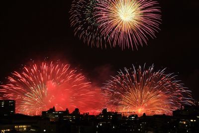 Low angle view of firework display at night