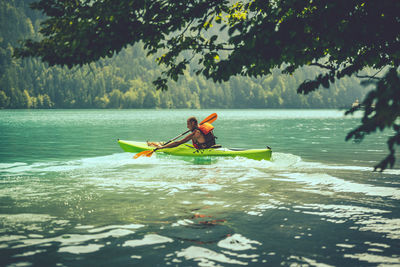 Man kayaking in sea