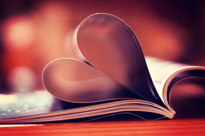 Close-up of heart shape pages folded in book